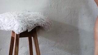 A lady in very high heels and a dress crosses her legs and leaves them dangling from her feet (2)