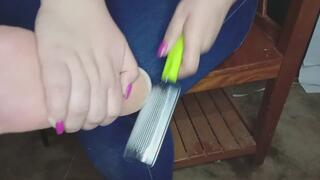 Chubby girl removes dirt from her heels with a cheese grater
