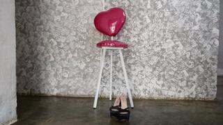 With high heels on her feet and short dress seated woman crosses her big legs (2)