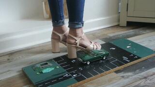 Priscilla toy car crush she crushes a 1960s Ford Mustang in block heels close left upper view