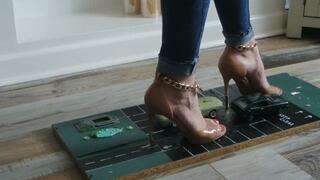 Priscilla toy car crush she crushes two cars a Ford Mustang & VW Scirocco in high heels close left upper view