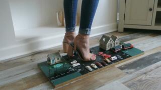 Priscilla toy car crush she crushes a tiny town with lots of small cars and buildings in big heels close left upper view