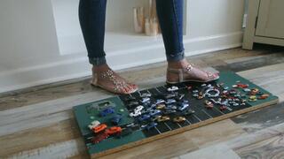 Priscilla toy car crush she crushes many tiny cars in flat sandals close left upper view