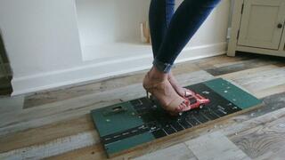 Priscilla toy car crush she crushes two 80s Camero's in pointed heels close left upper view