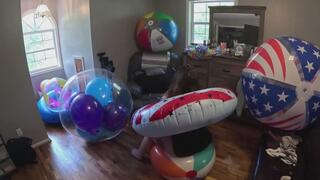 playing and popping balloon filled beach ball