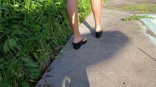 He first walks in flip-flops and then lets them dangle from his small feet (5)