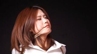 Bitch in business suit tied up on a chair