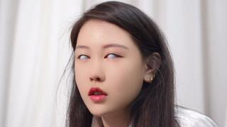 Model with white contact lenses touches something on the table with her feet Guess wrong I can play with her feet