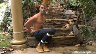 Bare chested blue eyed blonde sits bound in the great outdoors! 1080p Version