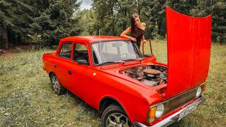 REVVING CRANKING Ellie revving and cranking on an old car