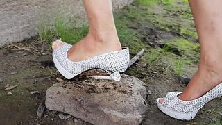 Expensive high heels at the river, high heels completely ruined, wrecked shoes, broken high heels