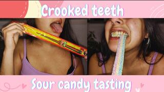 Crooked teeth chewing sour candy