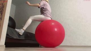 Alla is doing fitness and happily jumping on two huge yoga balls