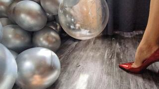 Katherine bursting balloons under her sexy red stilettos