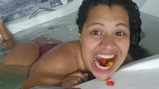 Giantess devouring gummy bears in the bathtub
