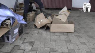 Cardboard boxes crushed under Heeled Boots
