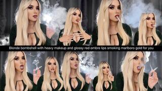 Blonde bombshell with heavy makeup and glossy red ombre lips smoking marlboro gold for you in a low cut top close up!