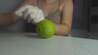 I sew a lemon together with a needle and thread, using a medical device