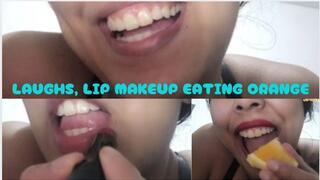 LAUGHTER, PAINTING LIPSTICKS, EATING JUICY ORANGE SHOWING TEETH, MOUTH FULL
