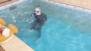 Alla wears a wetsuit and a diving mask and swims in the pool and fucks an inflatable reindeer that suddenly pops