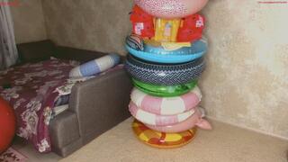 Alla wears a huge number of inflatable rings and is tied with them, which brings her to orgasm