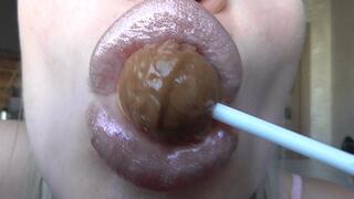 SUCKING A CHUPA CHUPSA WITH SHINY LIPS