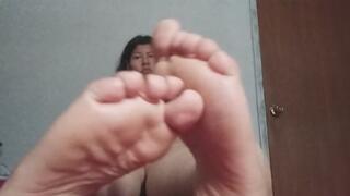 Chubby girl is bored so she plays with her feet
