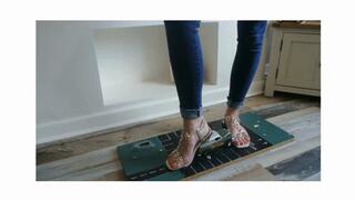 Priscilla toy car crush she crushes a 50s Chevy van & Ferrari in sandals left upper view