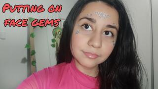 Putting shiny face gems on my face