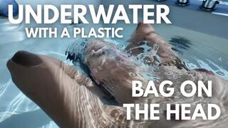 UNDERWATER WITH A PLASTIC BAG ON HEAD