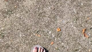 Tempest walking in grey flip flops and calves