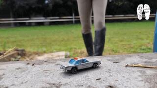Toy Cars under her old riding Boots