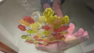 Bare feet stuck to glass with melted gummy bears