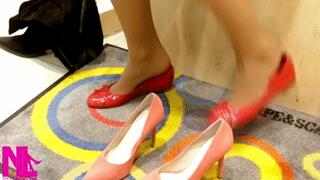 Trying new corral colored pumps and shoeplaying in a store
