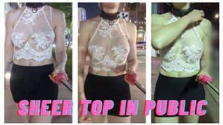 A very public walk with a white see-thru top