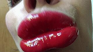 the gloss spreads across the lips m