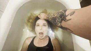 A frightened Milana practicing breath holding in her bathtub