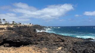 Naked girl naturist walking through the beach to the natural pool