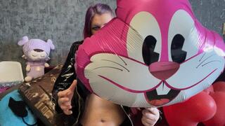 girl in latex poping foil balloons