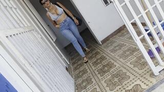 Milah merciless cranking in the Old Fiat Spazio 147 in jeans and flat sandals