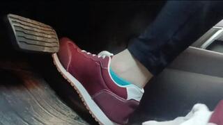 Evalynn driving a loaner truck in red sneakers