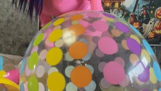 girl in pink dress play with dotted beachball