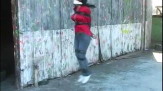 Gina Rae bound and gagged hopping through the old warehouse