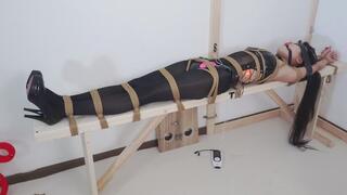 A sexy woman was tied up to a bench.