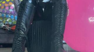 girl in boots poping balloons
