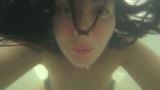 Blowing bubbles underwater in the bathtub Ba