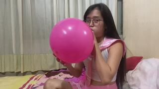 Looner Savannah student look blow to pop pink balloon