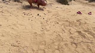 Quick pee in the sand on the nude beach