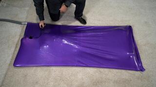 A girl experiences an orgasm in a lilac vacuum bed with an inflatable gag in her mouth