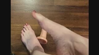 Miss Lex Measures Feet Against a 6 inch dlldo